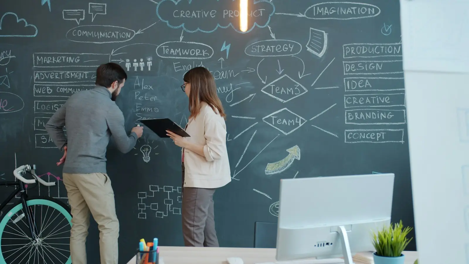 Brainstorming on a chalkboard wall
